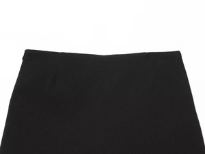 Close-up of black skirt waist featuring high-waist cut and side invisible zipper detail