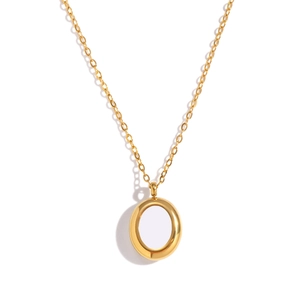 Detail shot of a minimalist gold round pendant necklace featuring a white center inlay