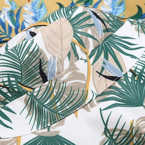Close-up of tropical leaf print and stitching on foldable summer sun bucket hat