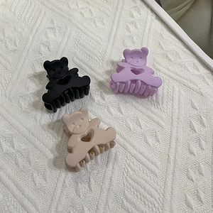Matte macaron bear hair claws in black, purple, and beige with heart cutout design