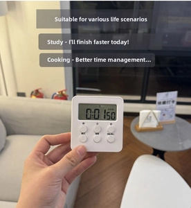 Handheld view of a white digital timer with large LCD display and functional physical buttons