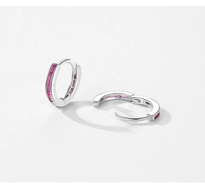 Detail of S925 silver hoop earrings with channel-set pink rectangular gemstones