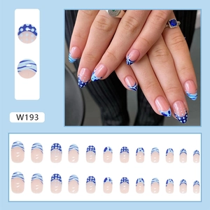 Detailed view of blue press-on nails with wave patterns and sea salt polka dots design
