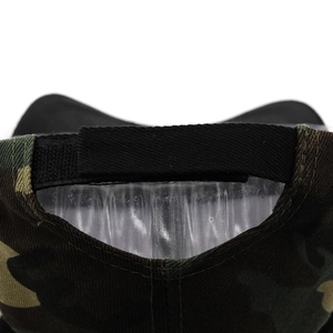 Detail of adjustable velcro closure on the back of camouflage baseball cap