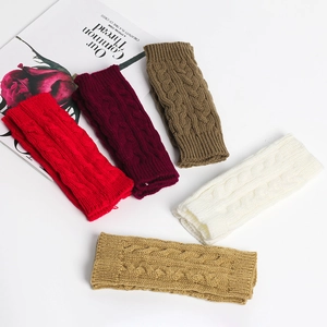 Detail of cable knit arm warmers in various colors including red, beige and white