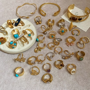 Flat lay of 18k gold plated stainless steel teardrop rings with turquoise stones