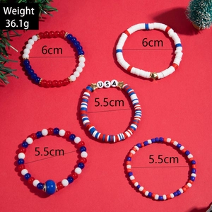 Detailed view of 5-piece Christmas beaded bracelets with USA letter beads and holiday charms