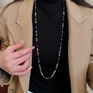 Detail of colorful faceted crystal beads on a bohemian long sweater necklace for women