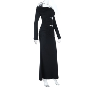 Detail of side cutout and ruched fabric on this black off-shoulder long sleeve maxi dress