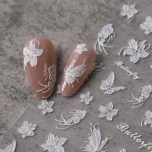 3D embossed white butterfly and floral nail stickers on nude manicure with marble background