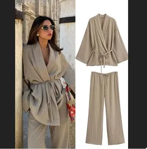Detail of two-piece khaki set showing waist tie-up top and drawstring wide leg pants