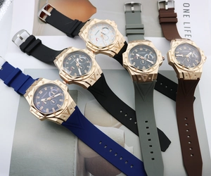 Multiple quartz sport watches with silicone straps and octagonal gold bezels on display