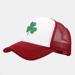 Close-up of red mesh baseball cap with green clover embroidery and breathable texture