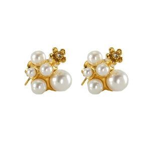 Detailed close-up of gold pearl cluster earrings with elegant metal flower and crystal