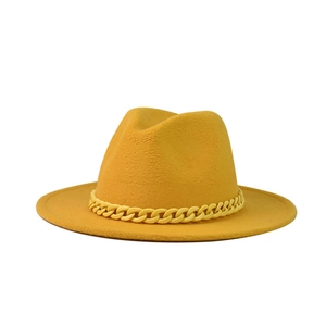 Close-up of bright yellow fedora hat featuring a matching thick decorative chain band