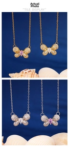 Detailed close-up of butterfly pendant necklace with micro-paved cubic zirconia stones