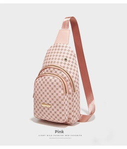 Close-up of pink crossbody bag with geometric pattern and dual zipper compartments