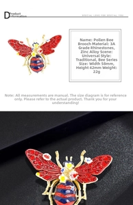 Detailed view of bee brooch with red rhinestones and blue enamel showing 58x42mm dimensions