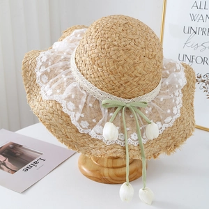 Handmade raffia sun hat with wide brim, delicate lace embroidery and tulip floral charms