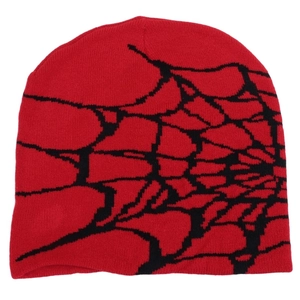 Detailed knit texture of red beanie with black spider web pattern for winter warmth