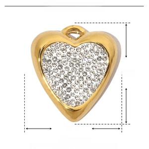 Macro detail of a 21mm gold heart pendant made of stainless steel with inlaid rhinestones