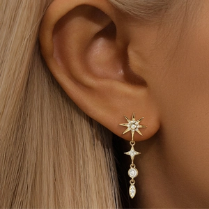 Macro shot of gold-plated S925 silver star drop earrings with sparkling cubic zirconia