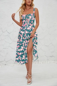 Detail of floral sleeveless dress with side slit showing pink flowers on teal fabric