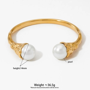 Irregular stainless steel twisted bangle with large white pearls on a gold-plated band