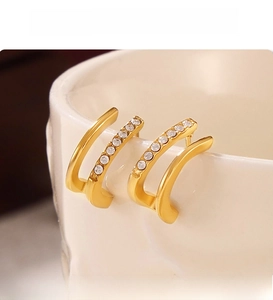 Detail of PVD electroplated gold double-layer C-shaped stud earrings with pavé crystals