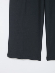 Detailed close-up showing the smooth hem and fine twill texture of these wide leg trousers