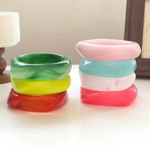 Close-up of colorful resin bangles with marble texture in minimalist home setting