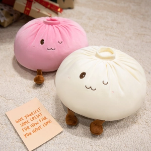 Cute steamed bun plush pillows in pink and cream colors with embroidered faces
