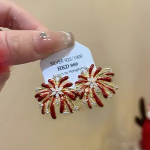 Close-up of red enamel firework earrings in S925 silver with sparkling zircon accents