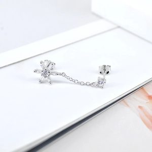 Macro detail of S925 sterling silver chain earring with sparkling zircon snowflake