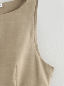 Detail of khaki dress neckline and stitching with size S label on woven fabric