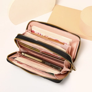 Interior view of black long wallet with double zippers showing spacious compartments