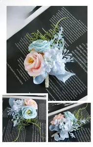 Close-up of handmade boutonniere with blue and peach roses, foliage and organza ribbon