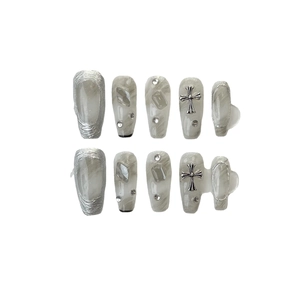 Handmade press-on nails set in smoky grey marble with silver gothic crosses and rhinestones