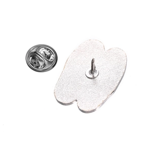 Detailed back view of silver metal brooch with butterfly clutch pin closure mechanism