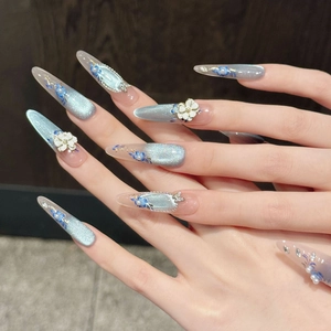 Blue cat eye press-on nails with 3D white floral patterns and elegant pearl accents