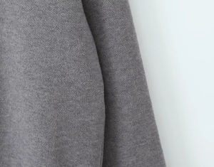 Close-up of the fine grey knit fabric texture on this three-piece women's clothing set