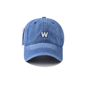 Front view of a vintage washed blue denim baseball cap with white embroidered letter W