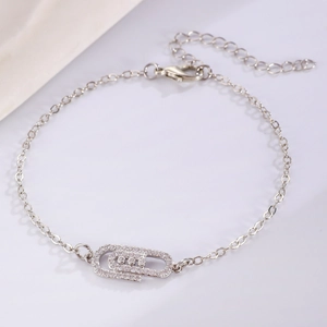 Detailed shot of silver paperclip bracelet with pavé stones and lobster clasp closure