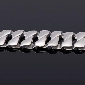 Close-up of silver Cuban link chain bracelet with polished stainless steel texture