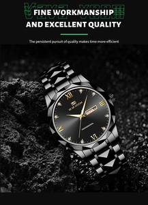 Detail of black stainless steel watch dial with gold markers on textured rock background