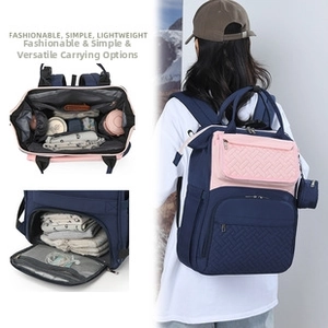 Detail view of pink and navy blue diaper bag with waterproof interior and storage sections