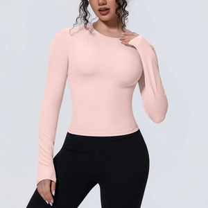 Détail du haut de yoga rose à manches longues montrant la coupe ajustée et le tissu mat