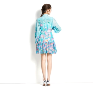 Back view of light blue daisy print dress with stand collar and lantern sleeves
