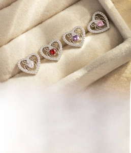 Detail of silver heart spider cartilage stud with sparkling zircon inlay in velvet display box