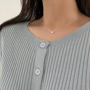 Minimalist 925 sterling silver heart pendant necklace worn by a female model